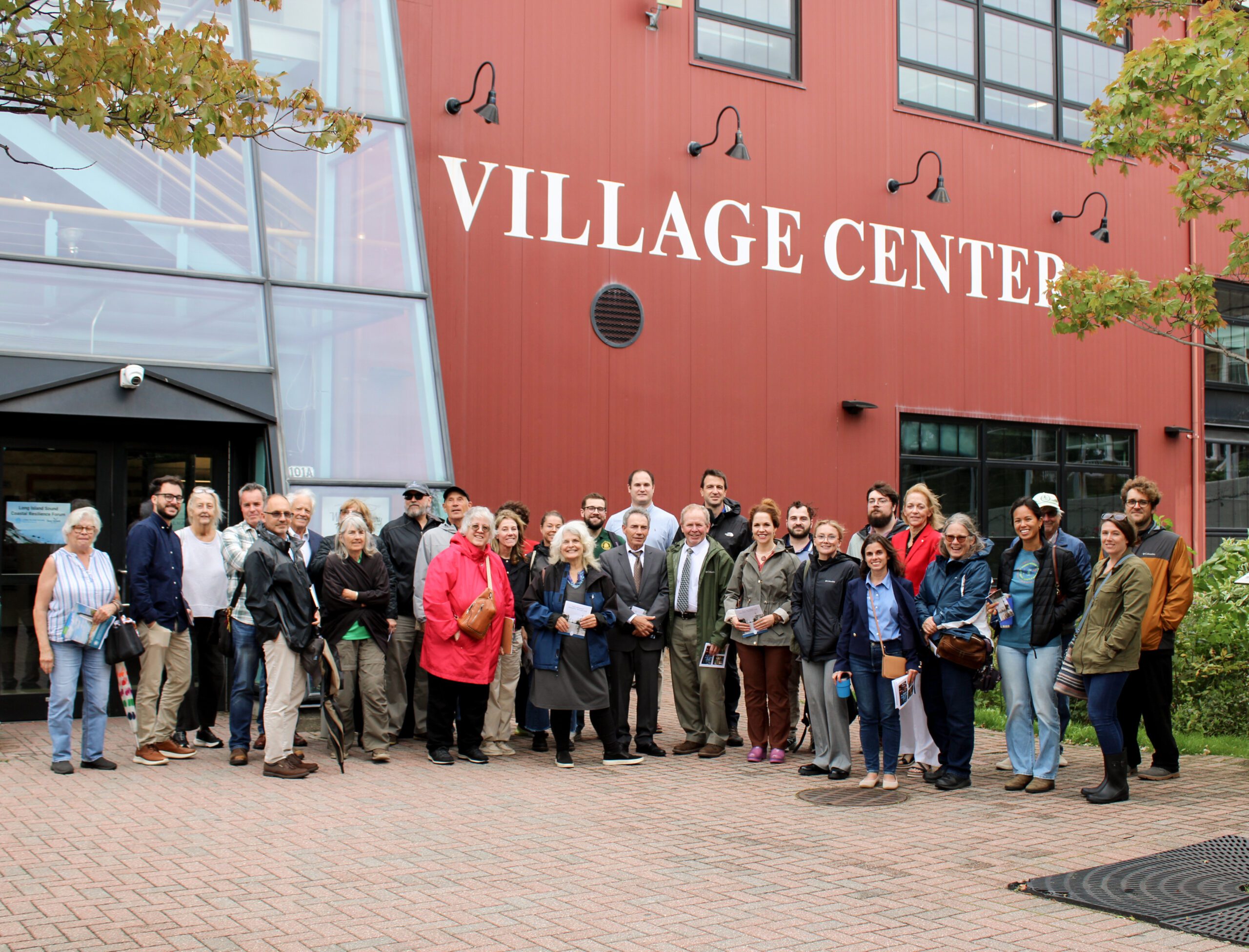 Forum attendees gather outside the Port Jefferson Village Center for a walking tour led by Village Mayor Lauren Sheprow. 